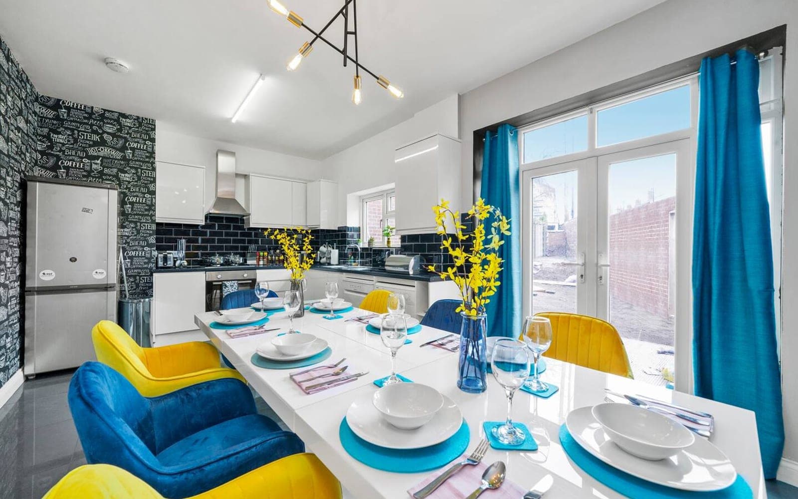 Dining table laid for eight beside the kitchen at Springfield Road, Coventry