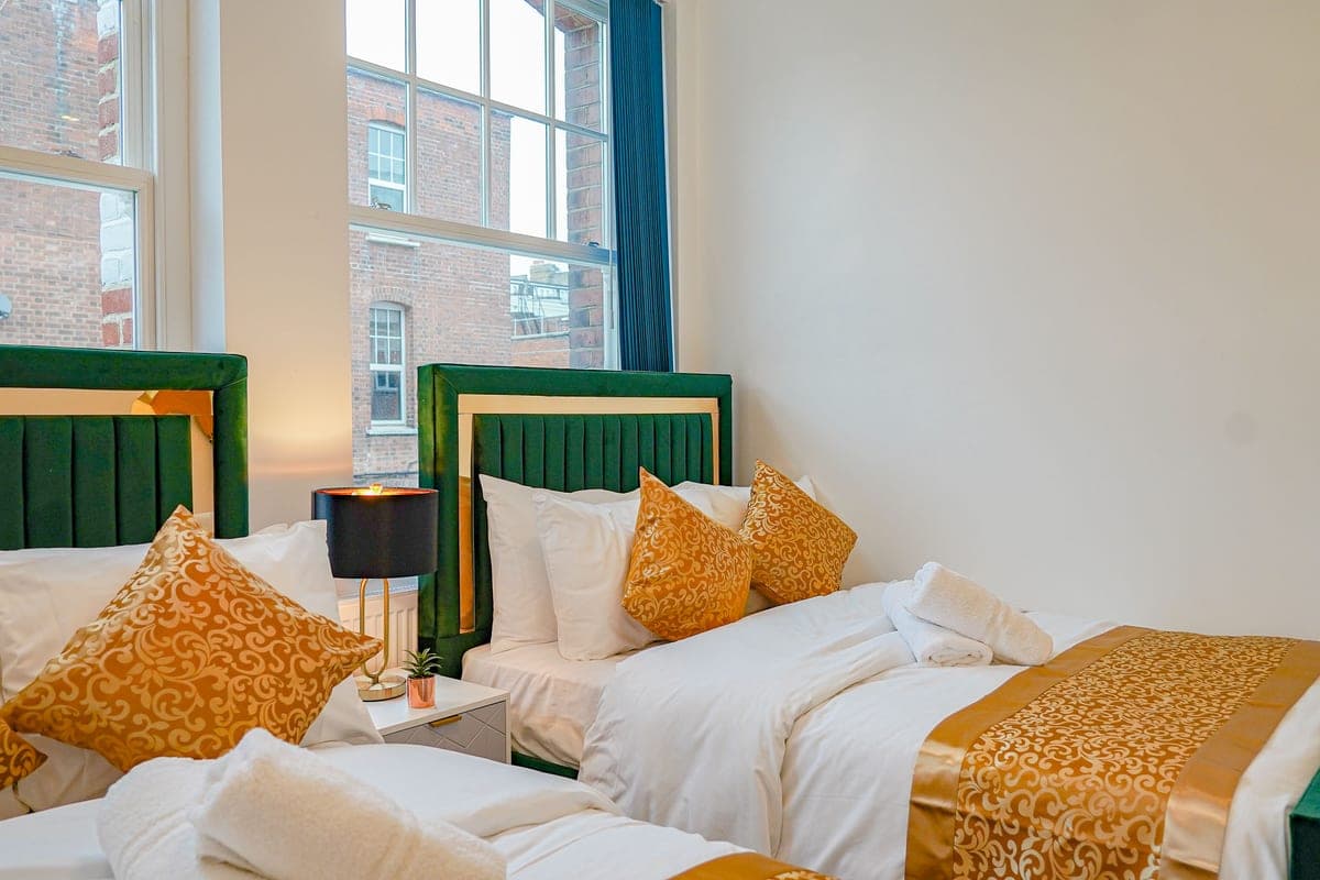 Double bedroom with a green velvet headboard