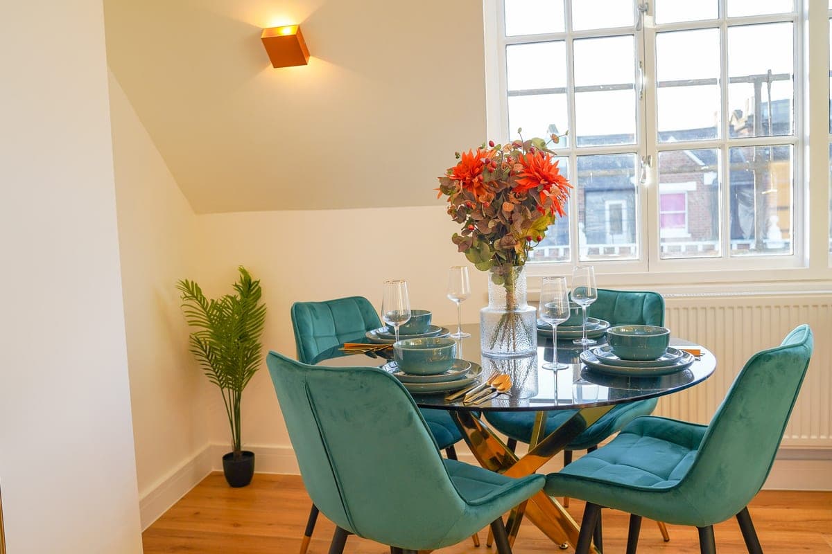 Kitchen island with yellow bar stools and a green sofa