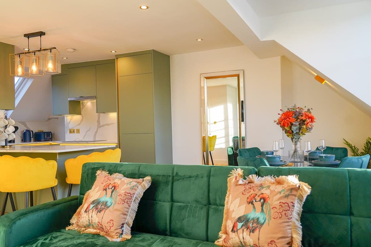 Bedroom with a green and gold headboard