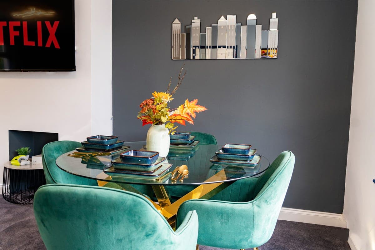 Dining area with teal velvet chairs