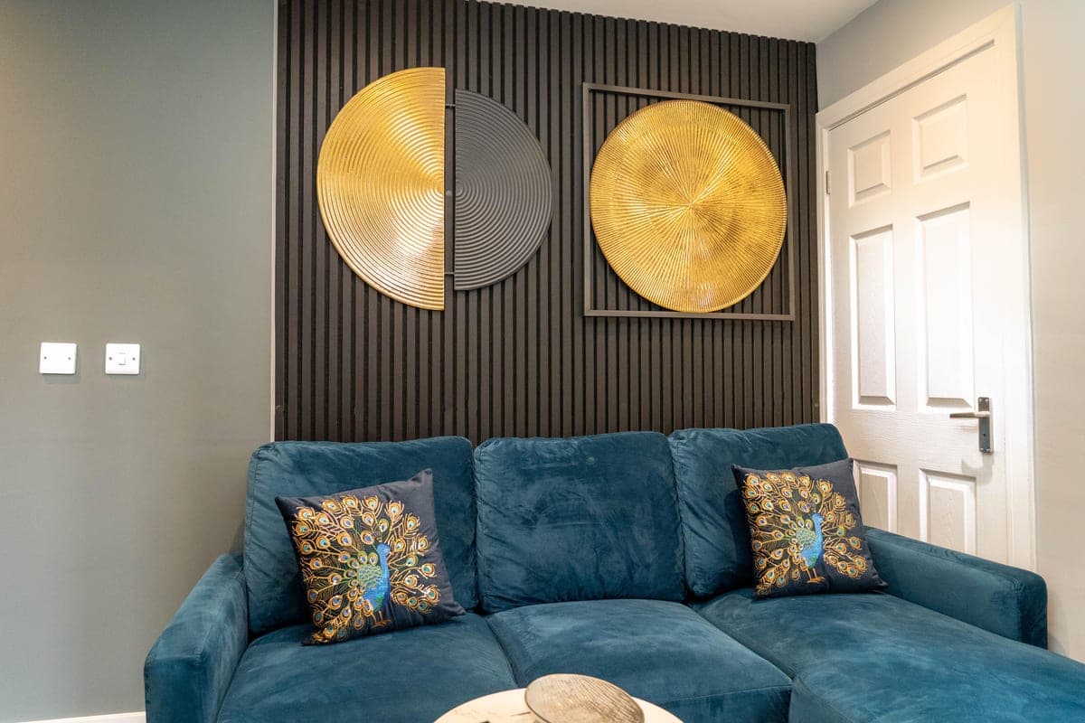 Bedroom with walnut panelling and brass lighting