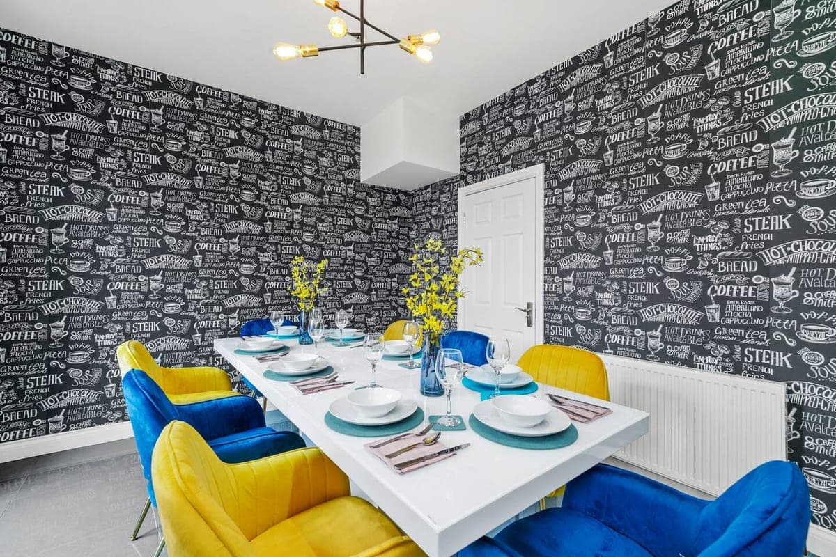 Dining table against a patterned feature wall