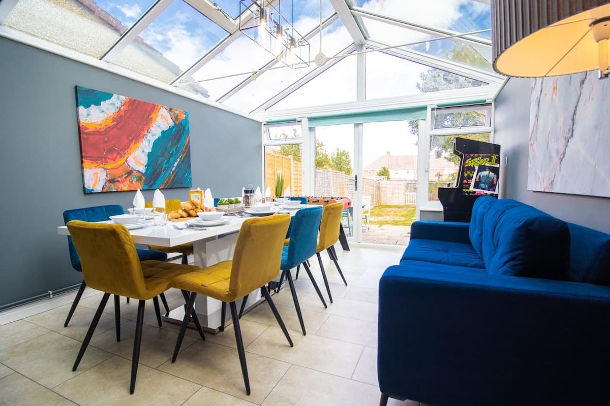 Conservatory dining room laid for nine guests