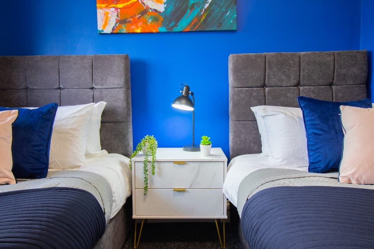 Living room with a colourful rug and blue sofas